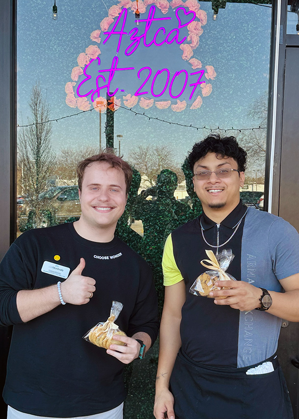 A team member at The Montvale Senior Living smiles alongside a local business owner at Aztca.